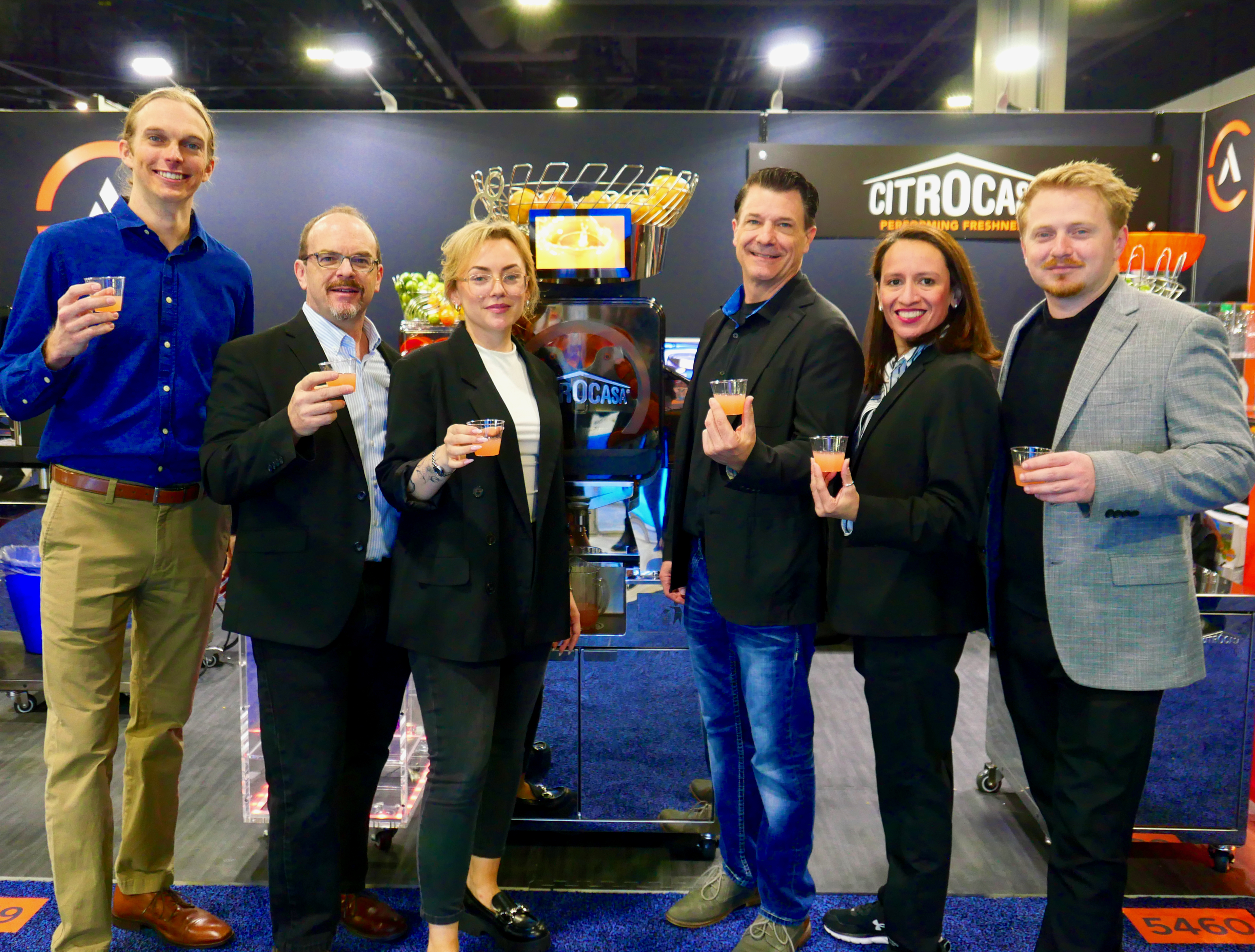 The Citrus America team from L-R: Stephen Farinhas, Brian Framson, Miriam Framson, Jay Gardner, Sandy Bosch, Jacob Framson. Equipment shown: CITROCASA xPro with large pressing kit juicing fresh pink grapefruit juice.